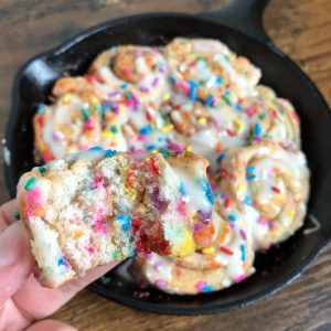 Close up of Funfetti Cinnamon Buns in a cast iron pan.