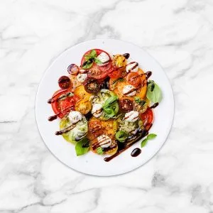 An Allenjoy Double Sided Photography Background with a caprese salad posed on it..