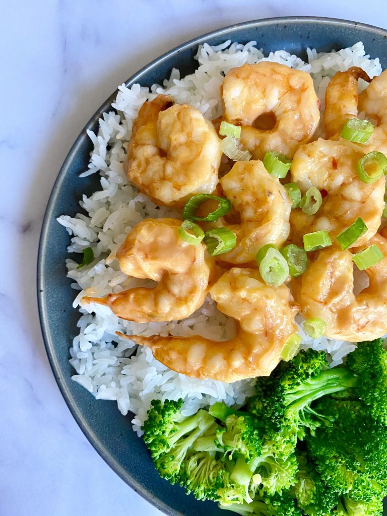 plate of healthy bang bang shrimp with rice and broccoli