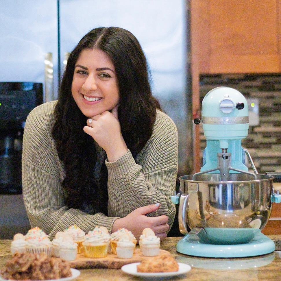 Jacklin posing with her baby blue Kitchenaid Professional Series Mixer.